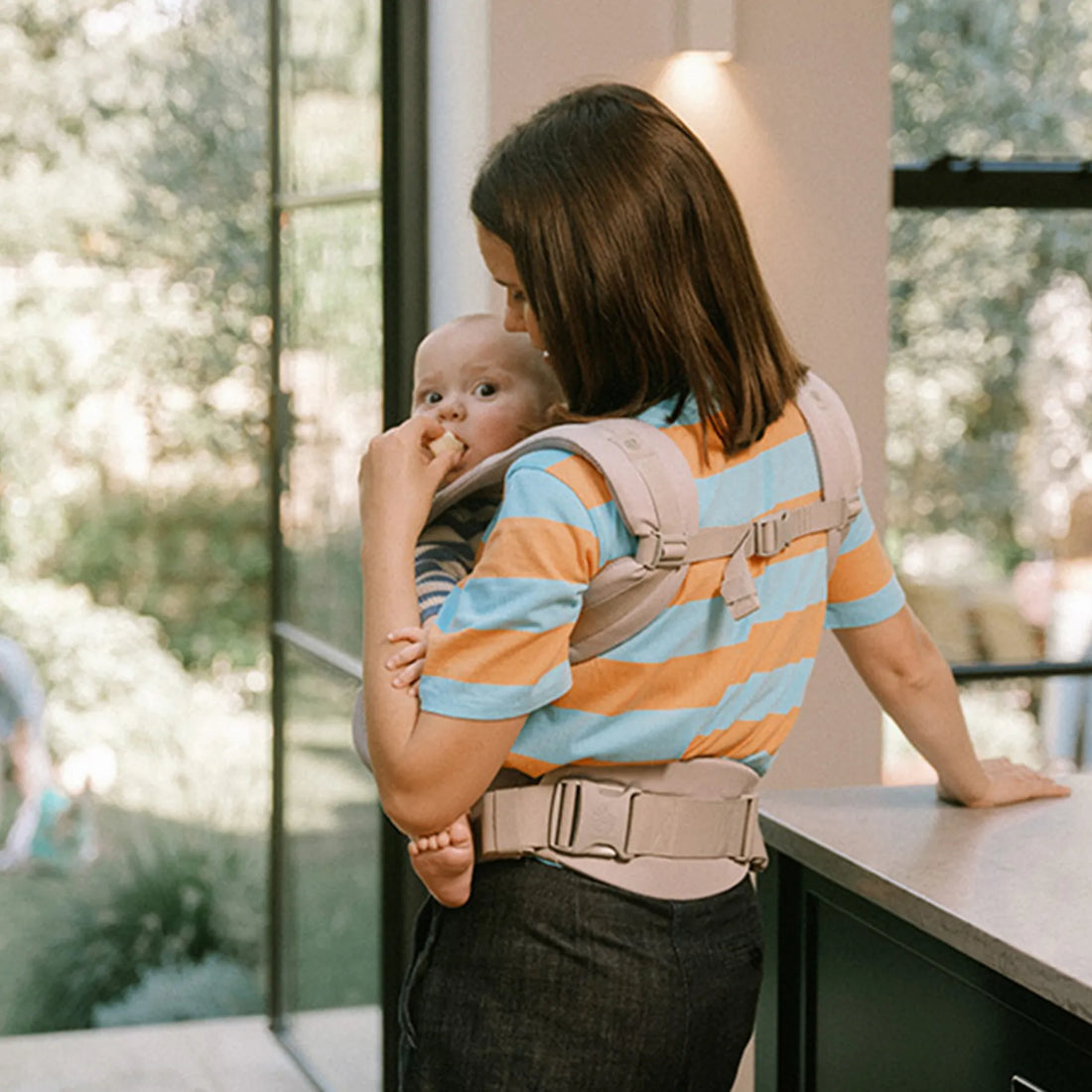 Woman holding a baby in a baby carrier