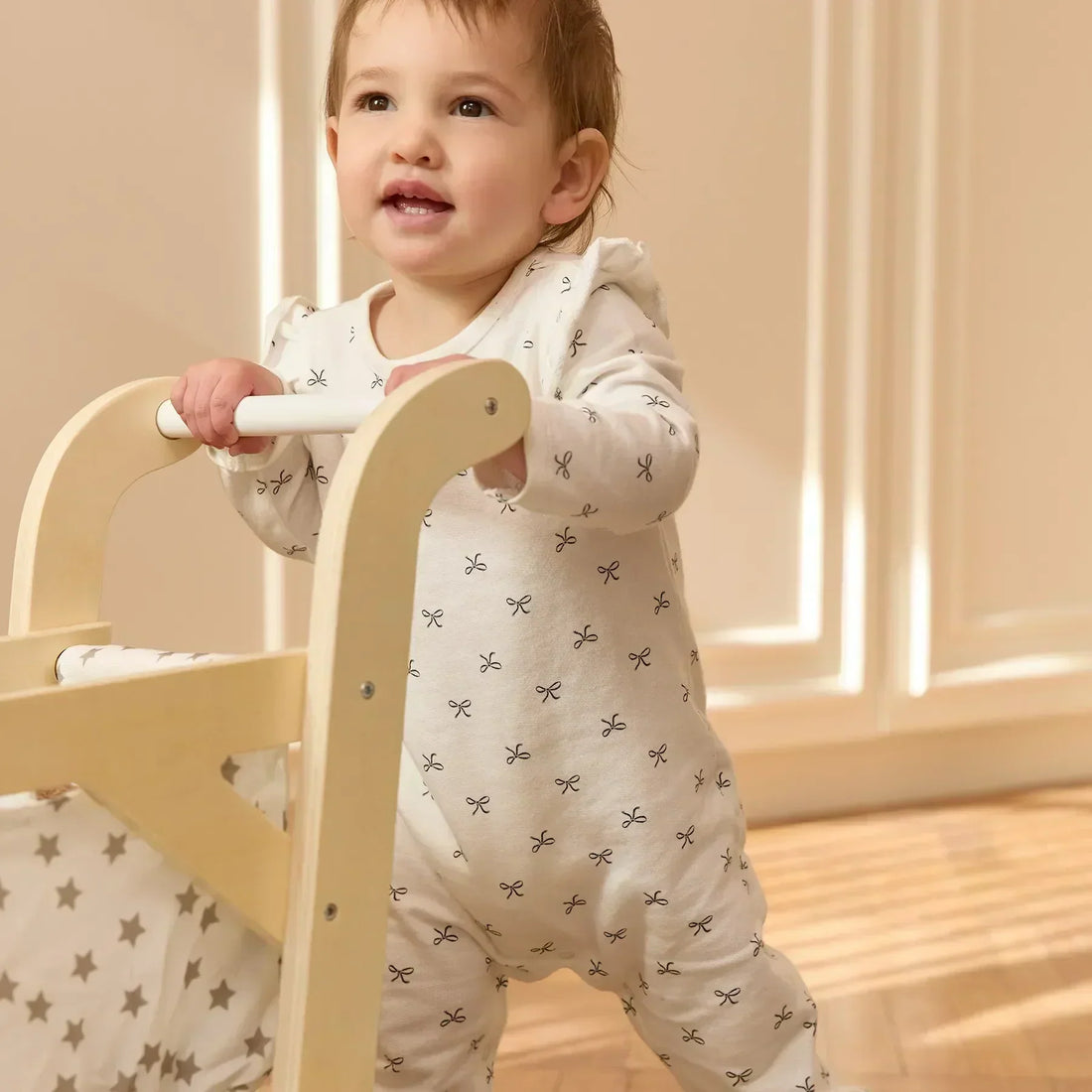 Baby pushing a toy stroller