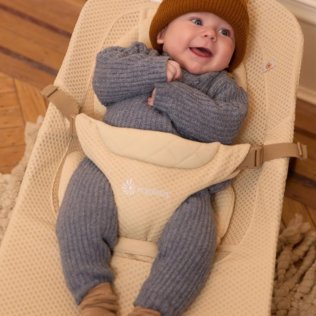 Baby in a white baby bouncer