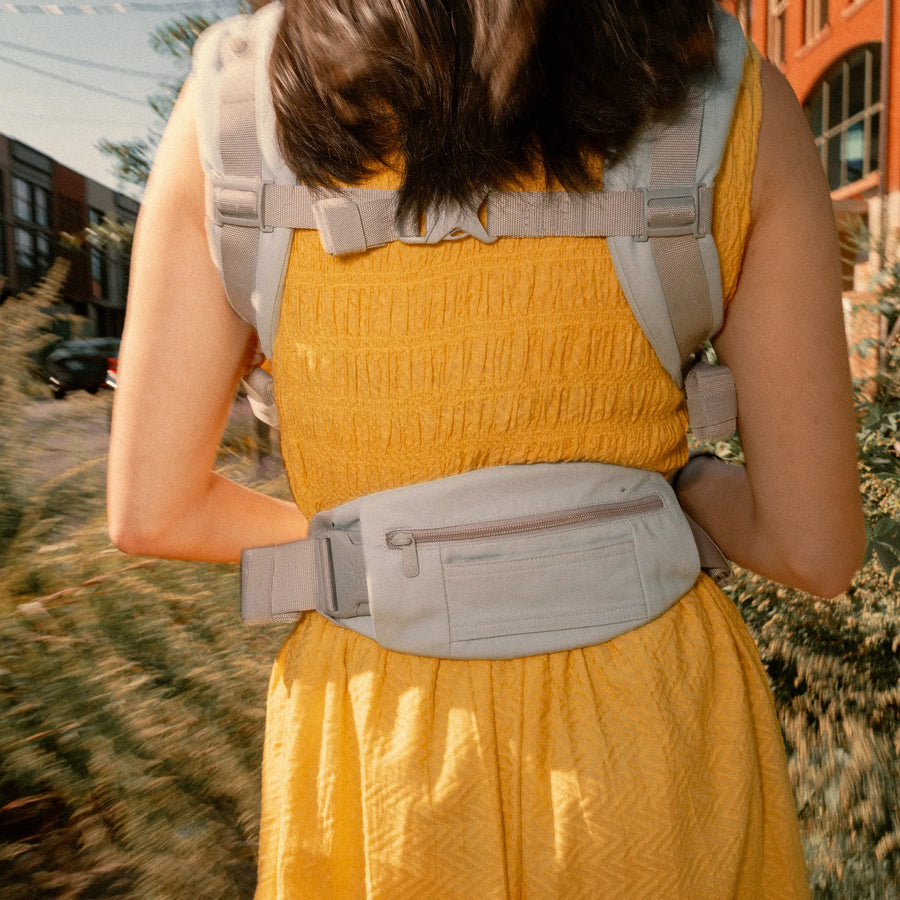 Back of woman wearing a baby carrier