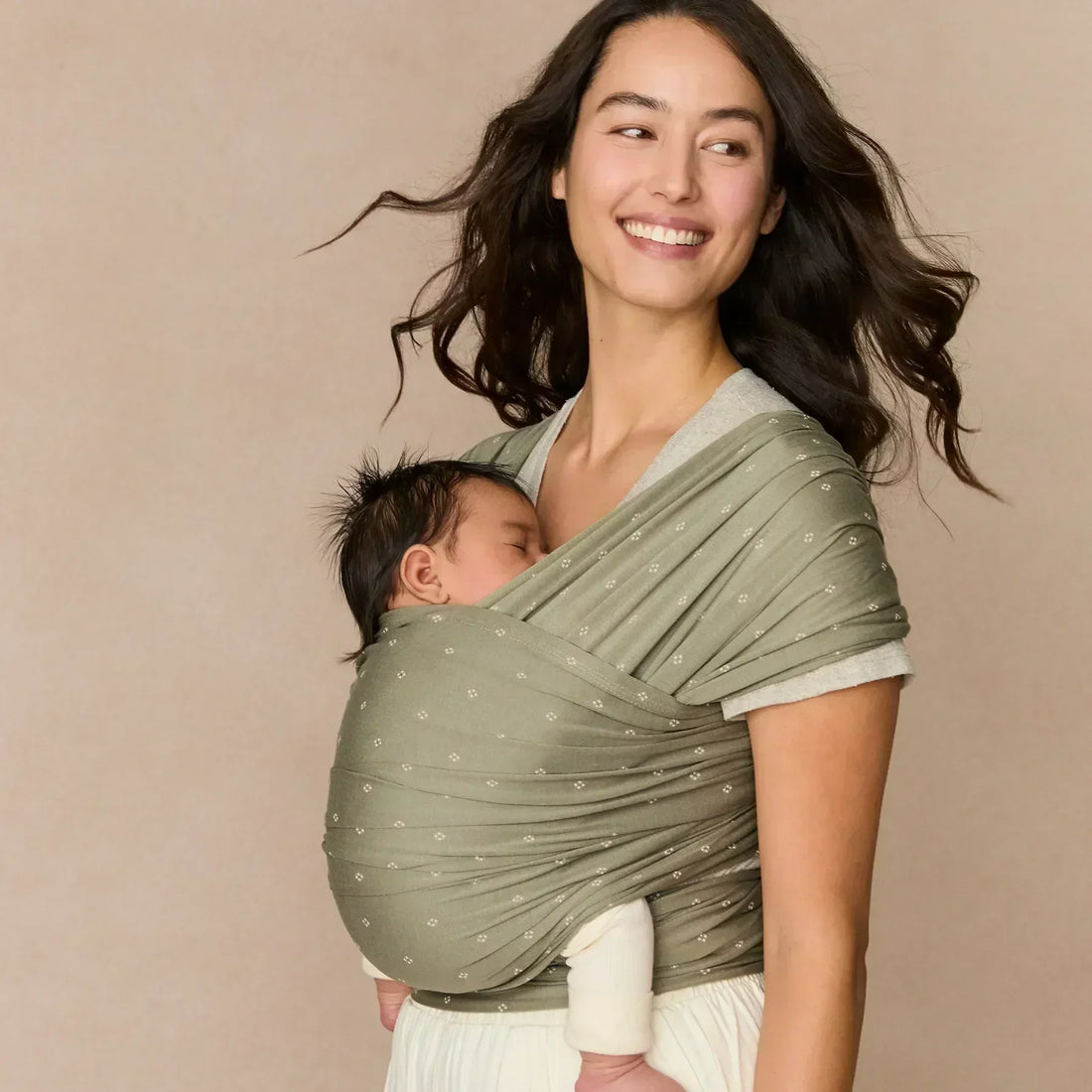 Woman holding a baby in a wrap 
