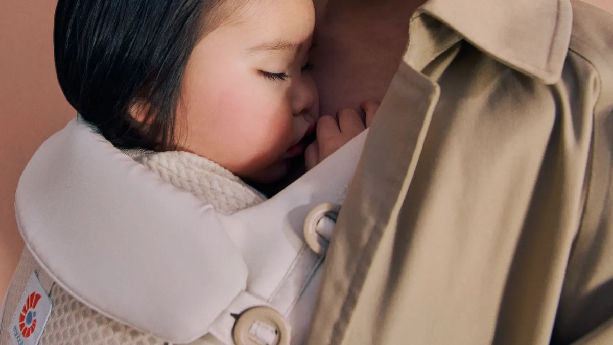 Baby sleeping in her comfy ergobaby omni deluxe baby carrier