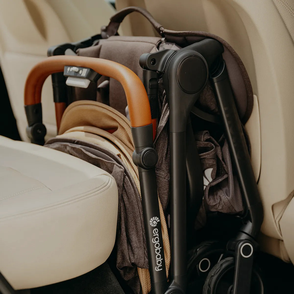 Folded Ergobaby Metro3 Compact Stroller neatly folded inside a car seat
