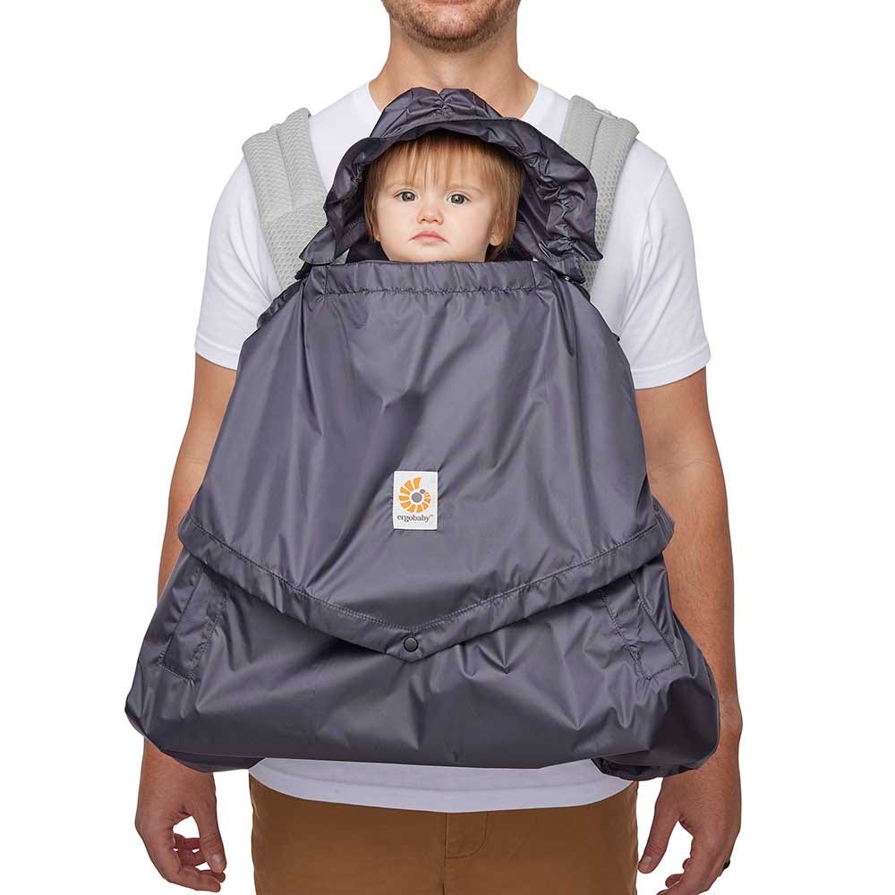 Dad wearing a baby in the Rain and Wind Carrier Cover: Charcoal | Ergobaby United States