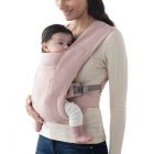 Mom wearing baby inward facing in Blush Pink Embrace 