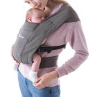 Mom wearing baby inward facing in Heather Grey Embrace 