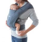 Mom wearing baby inward facing in Oxford Blue Embrace Baby Carrier