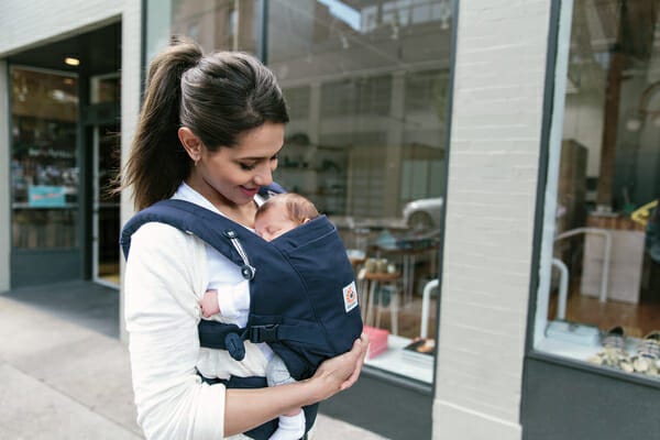 A woman with her baby in an Ergobaby Adapt Carrier