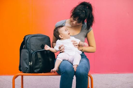 woman smiling at baby on her lap