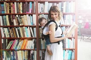 woman carrying baby on her back with Ergobaby carrier