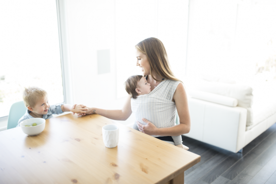 Mom holding baby in Ergobaby Aura Wrap