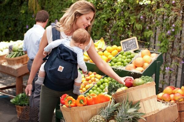 mother shopping with baby in wrap