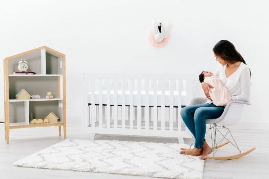 Woman sitting in nursery with baby