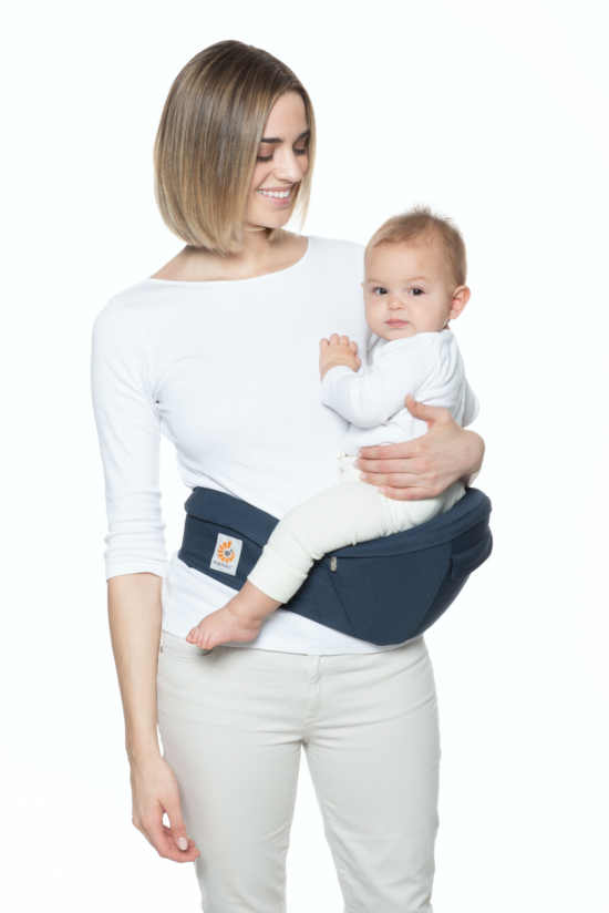 woman holding baby in ergobaby hip seat carrier