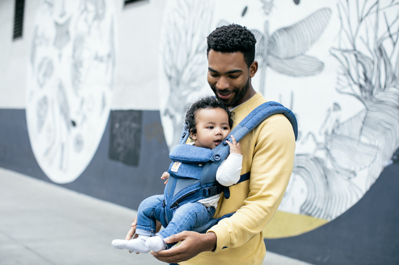 dad holding baby in Ergobaby Baby Carrier